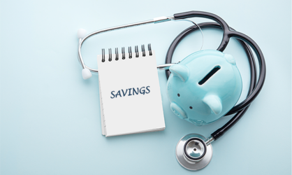 A small spiral notebook with the word savings written on it next to a light blue piggy bank with a stethoscope around it on a light blue background